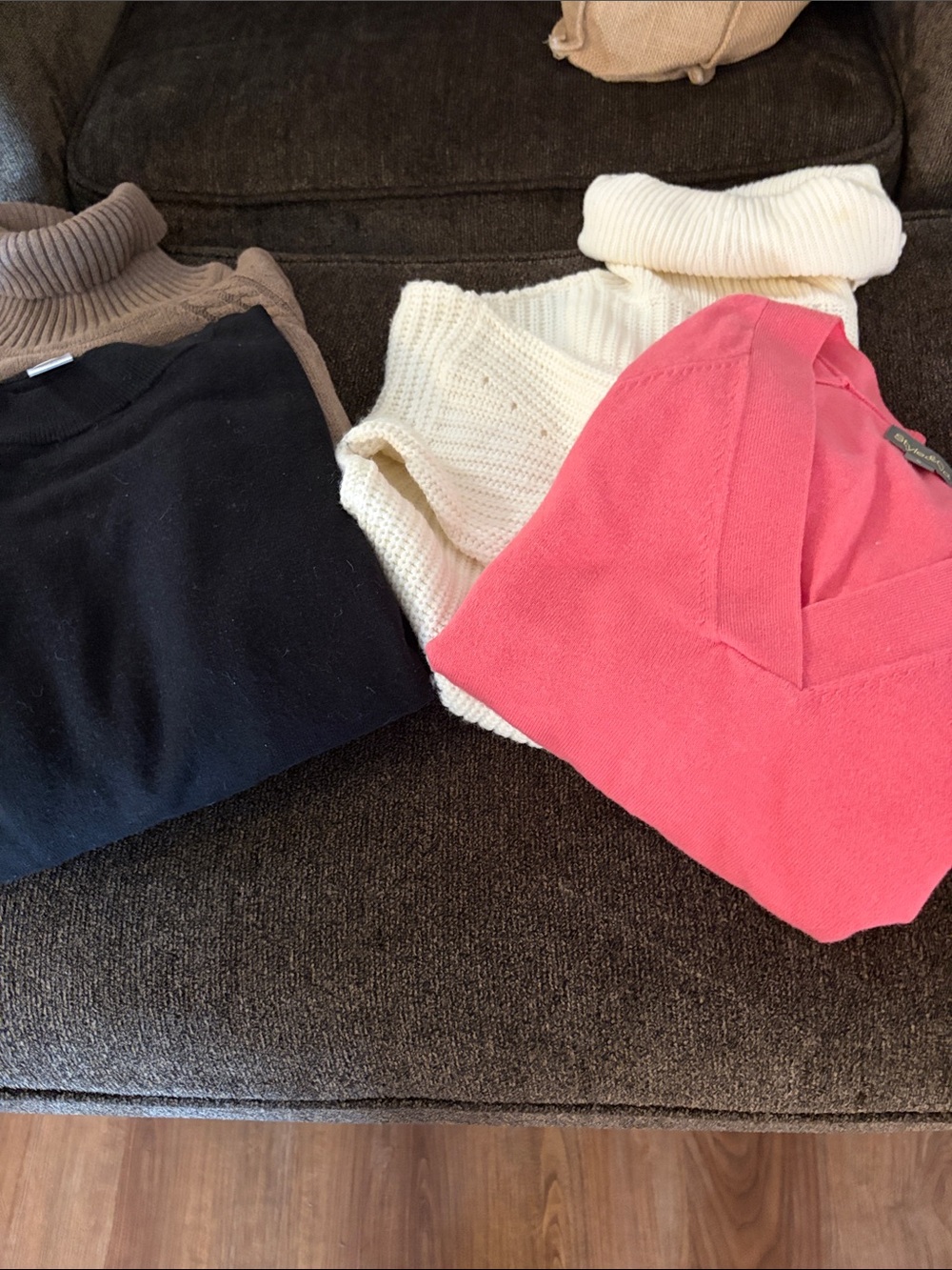 Various women’s sweater tops including a Calvin Klein